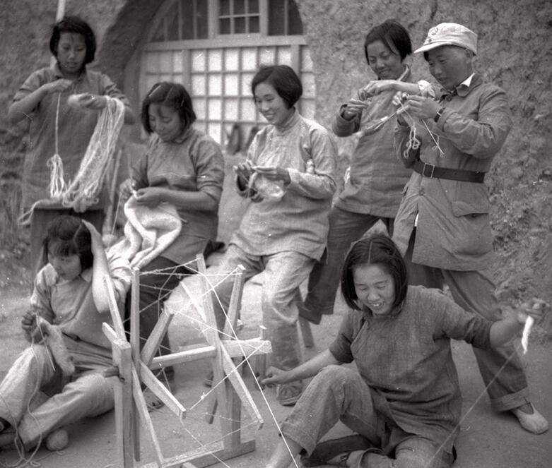 图为晋察冀边区女干部纺线织衣。